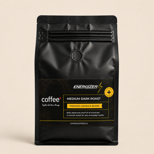 A black stand-up coffee bag labeled Energizer Coffee+ Medium Dark Roast, shown against a plain warm beige background.